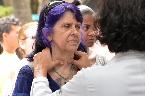 Woman getting her glands checked thyroid