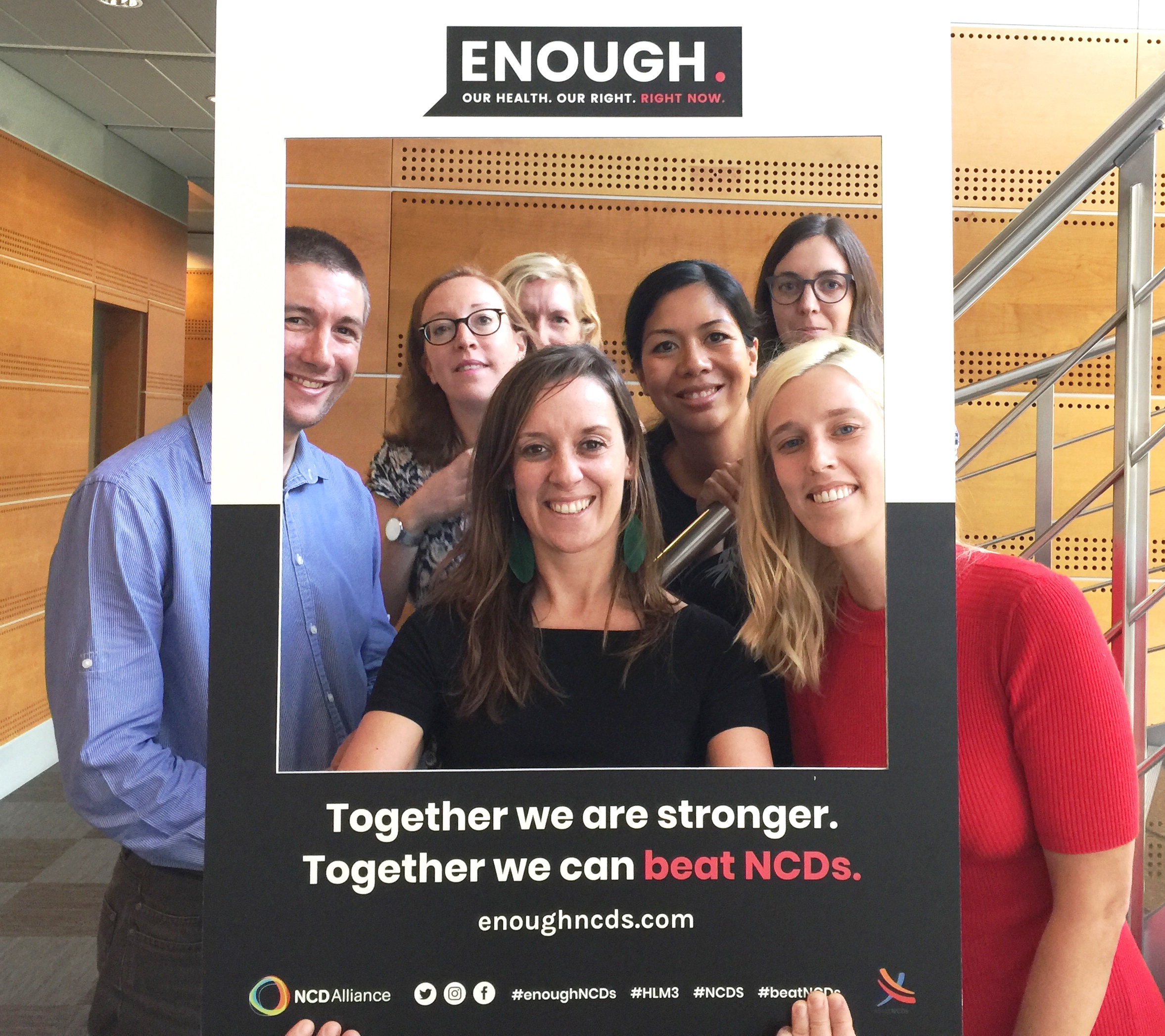 Staff from Union for International Cancer Control (UICC) appear in a giant frame, with branding of the ENOUGH NCDs campaign.