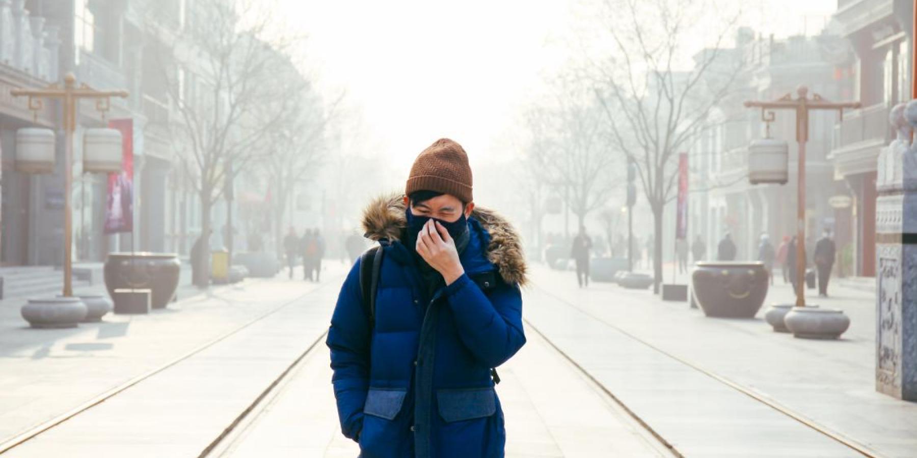 Man walking in Beijing air pollution