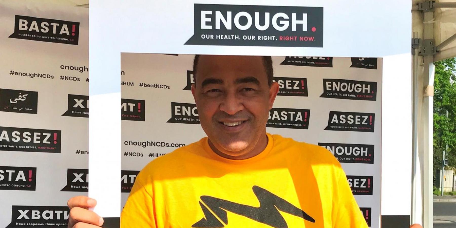 Jamaica's Minister of Health, Dr Christopher Tufton, framed by NCDA's Enough campaign at the WHO Walk the Talk event in Geneva, 20 May 2018