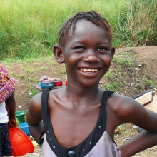 A girl smiles among vendors at a roadside Ebola check point in Port Loko Sierra Leone. 